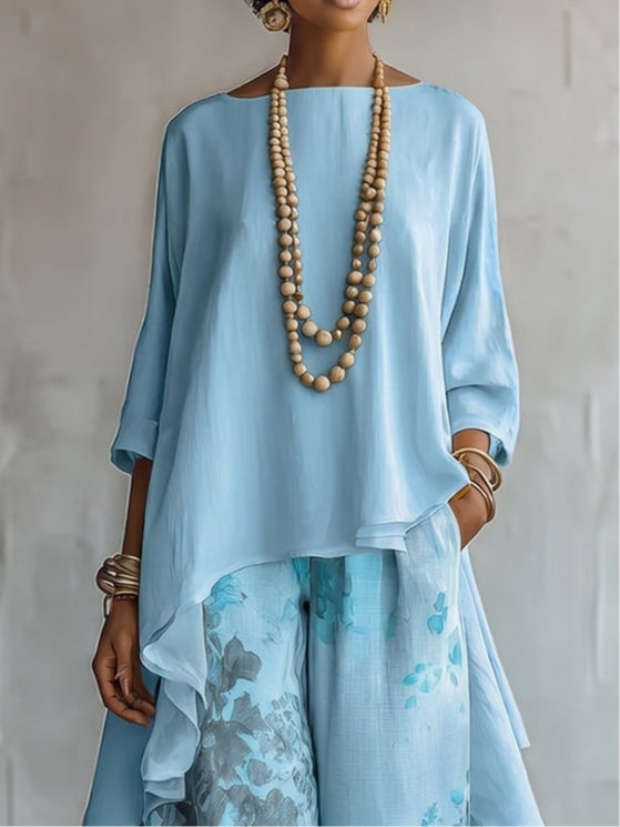 Caterina - Completo con top blu asimmetrico e pantaloni floreali a palazzo