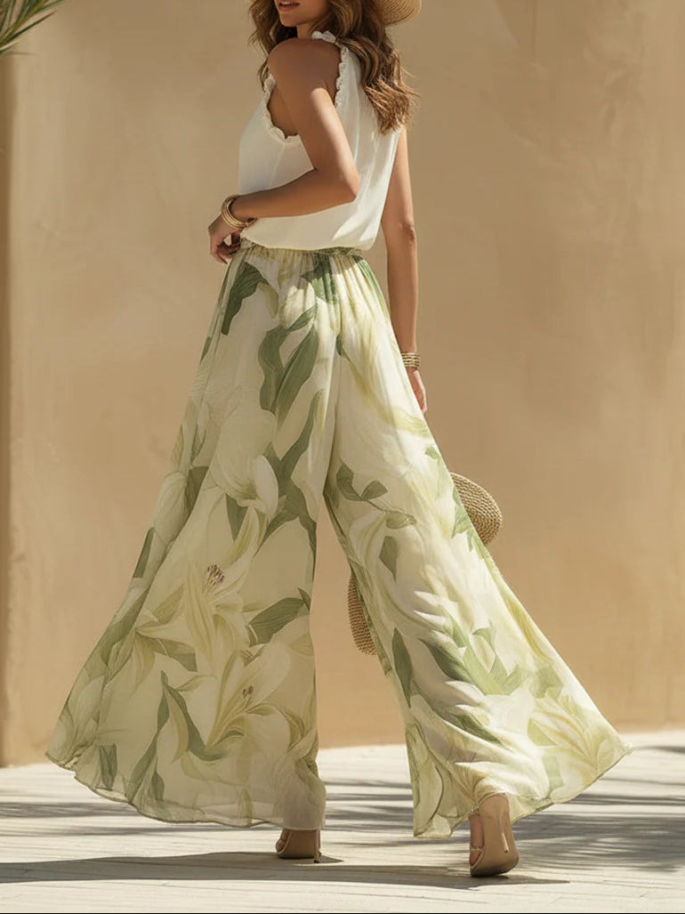 Cinzia - Completo da vacanza con top in chiffon senza maniche e volant e pantaloni a stampa di gigli